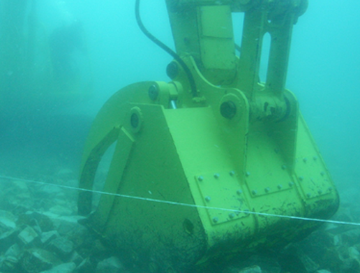 水中バックホウの基礎工事　基礎捨石・被覆石工